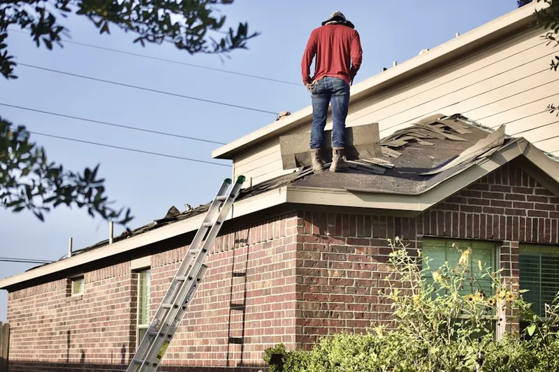 Professional roofer working on a residential roof in West Rushville